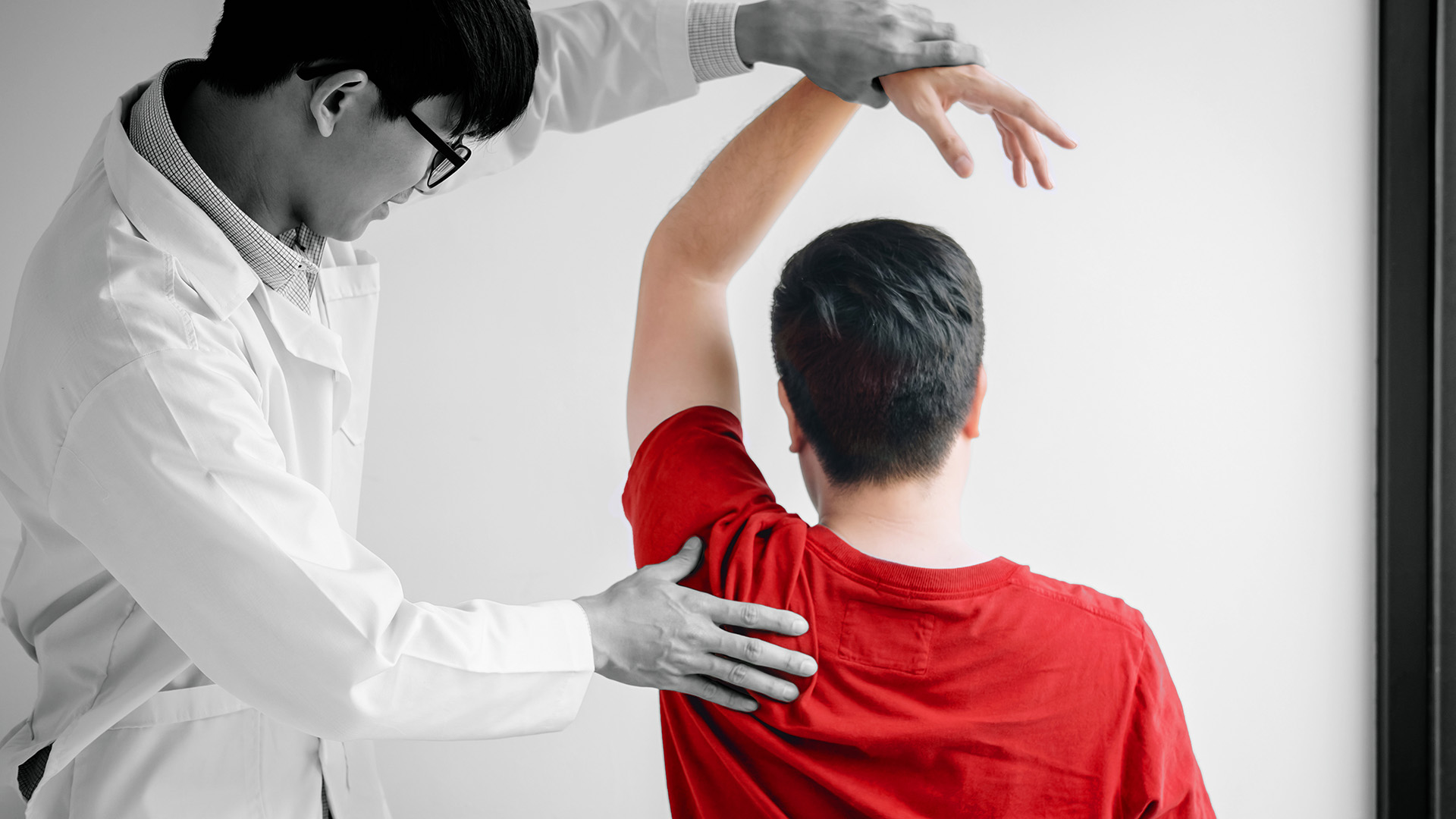 doctor helping a person stretch their shoulder and arm