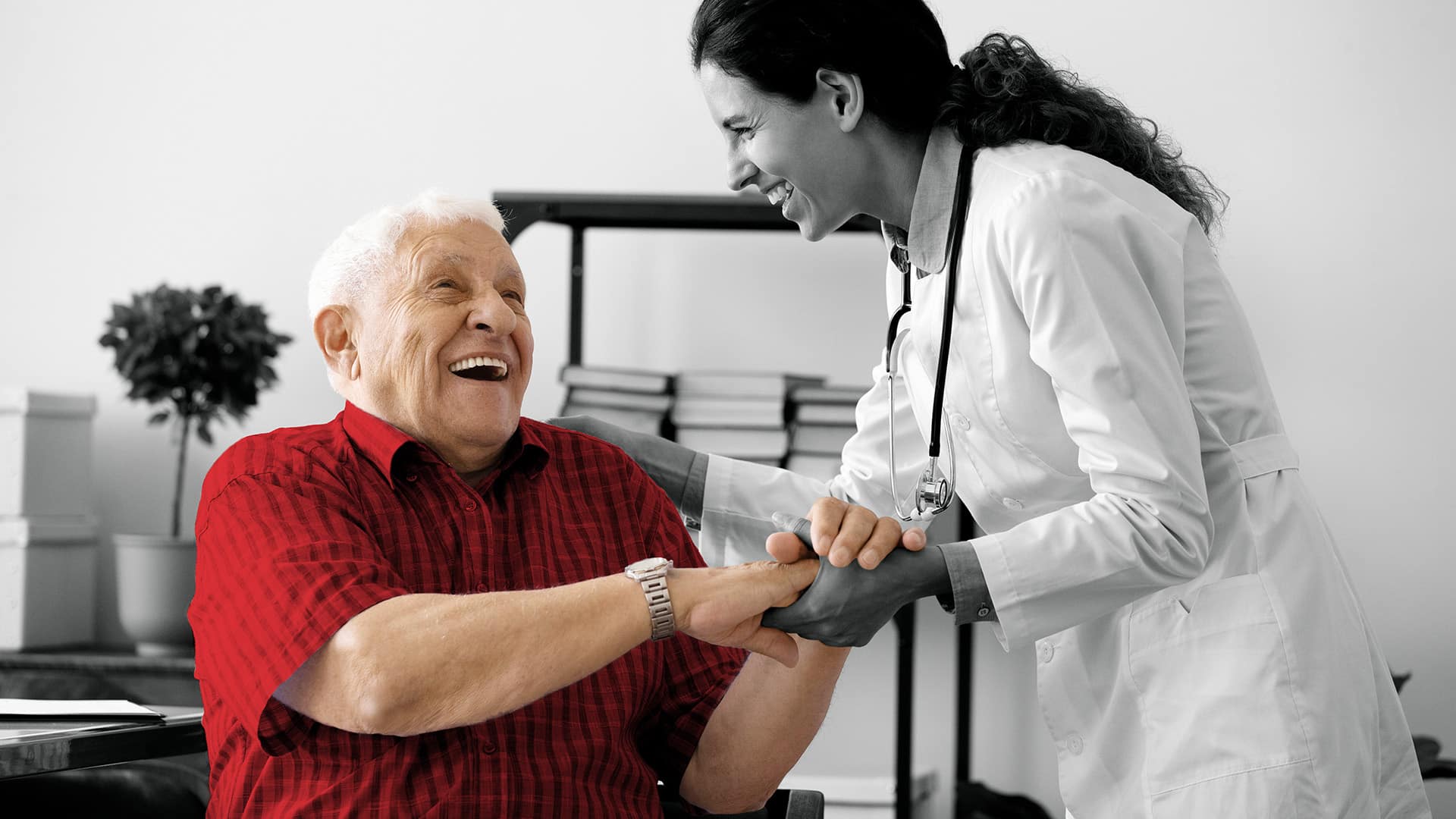 man jovially speaking with his primary care physician